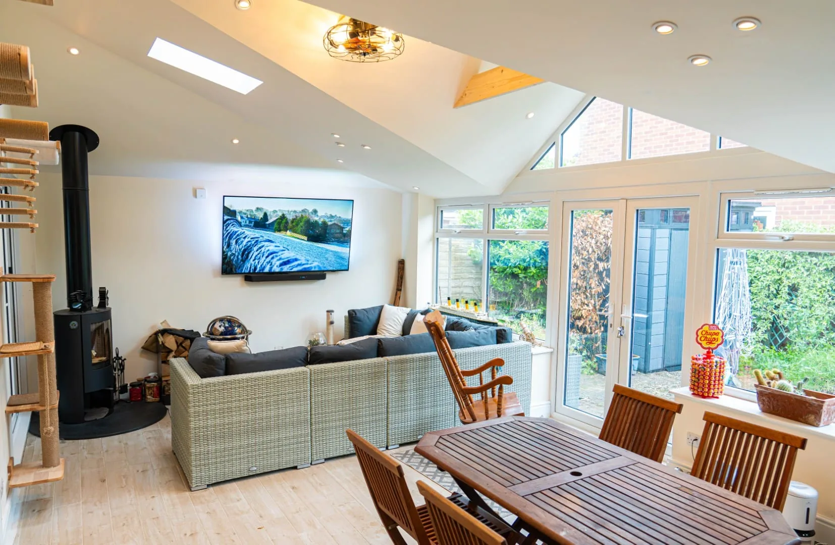 Inside a conservatory with a new tiled roof: plastered vaulted ceiling, roof window and log burner