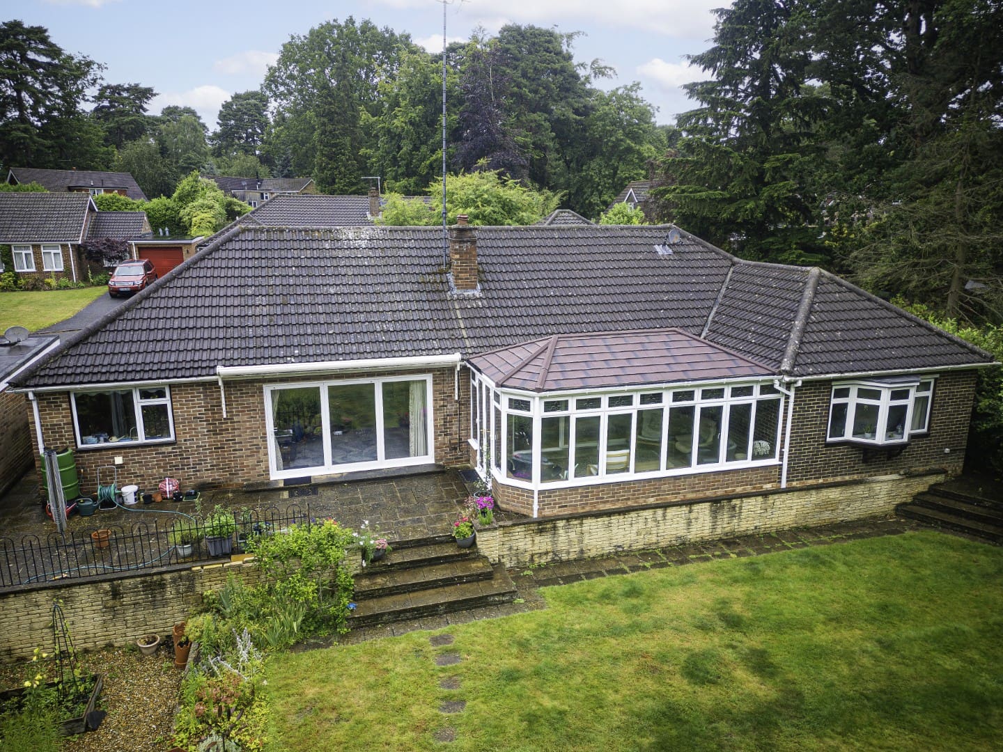 Grey tiled conservatory roof on a bungalow, seen from above