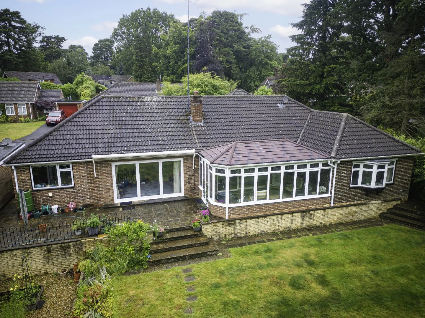 Grey tiled conservatory roof on a bungalow, seen from above