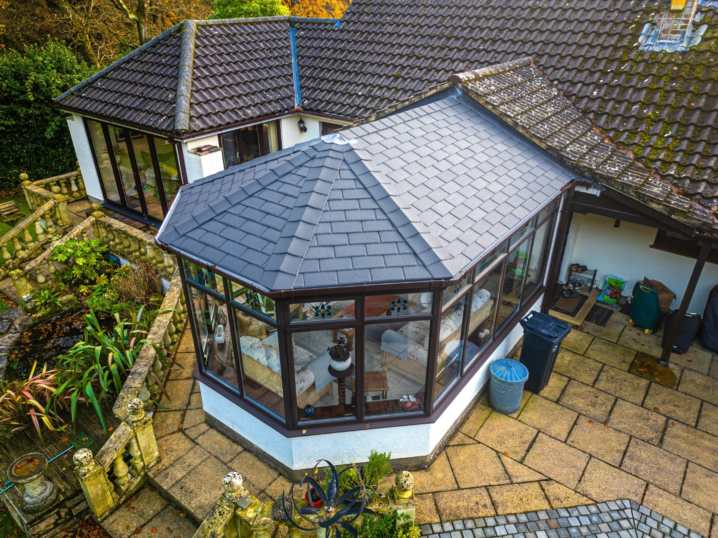 Brown tiled conservatory roof with black frames