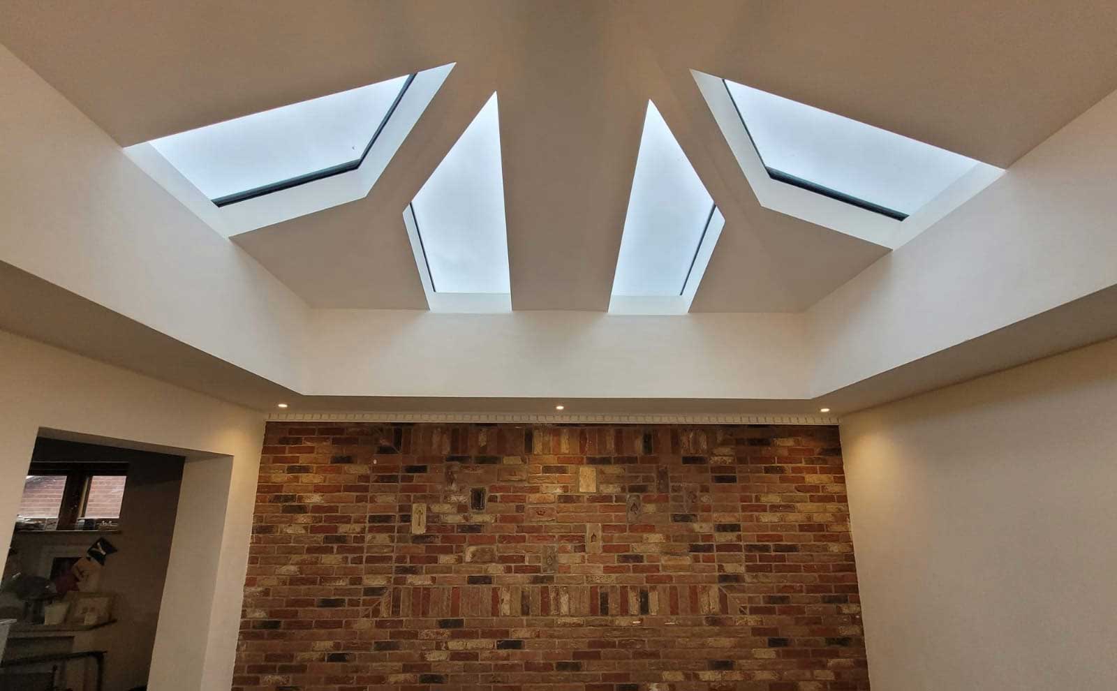 Vaulted plastered ceiling with roof windows inside a tiled-roof conservatory