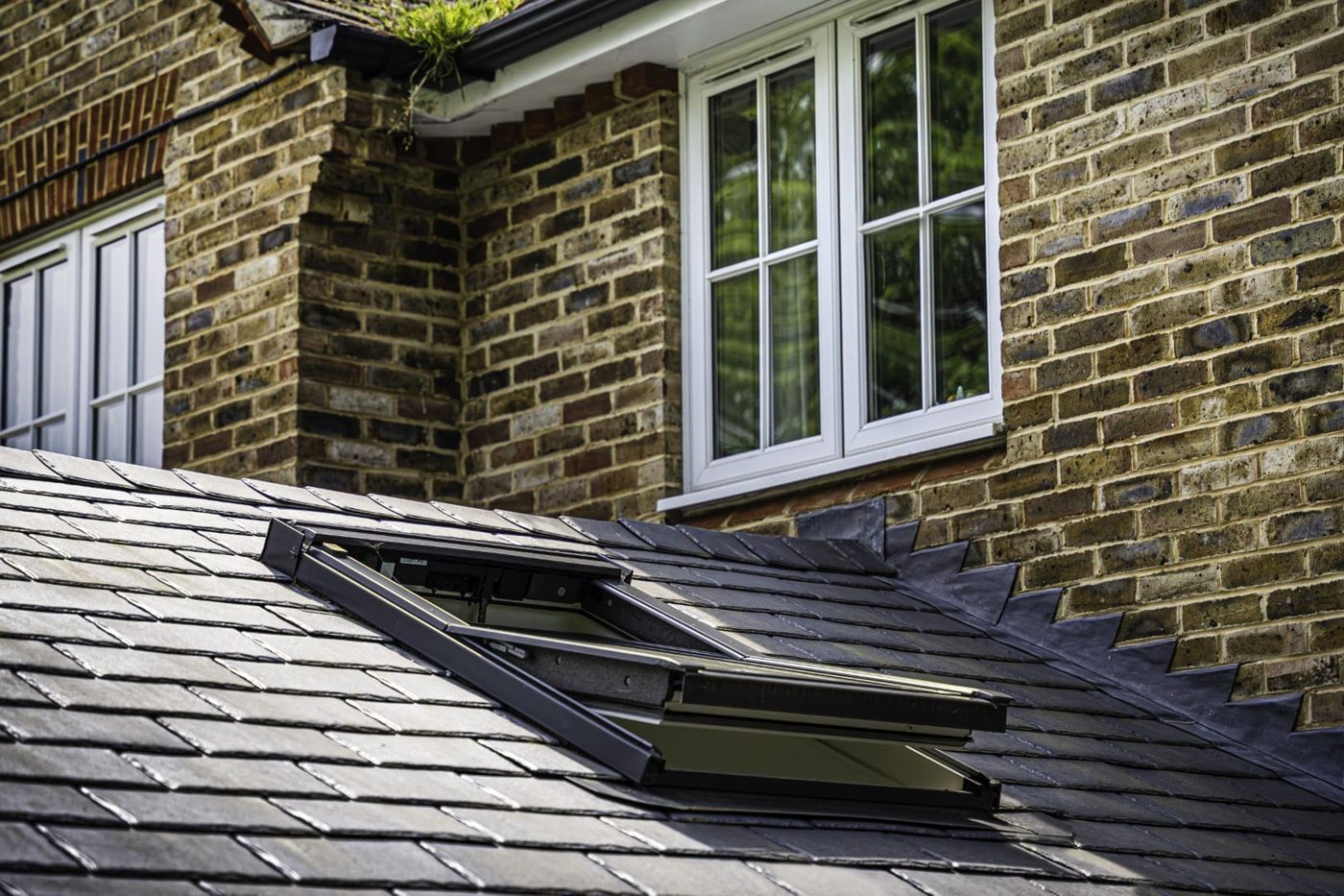 Roof window set into a slate-effect tiled conservatory roof